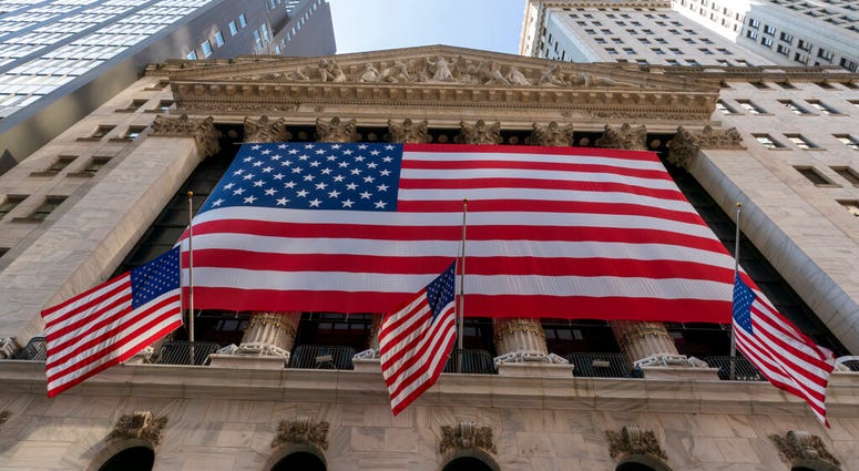 FILE - In this Monday, Sept. 21, 2020, file photo, a giant American Flag hangs on the New York Stock Exchange. (AP Photo/Mary Altaffer, File) FILE - In this Monday, Sept. 21, 2020, file photo, a giant American Flag hangs on the New York Stock Exchange. (AP Photo/Mary Altaffer, File)