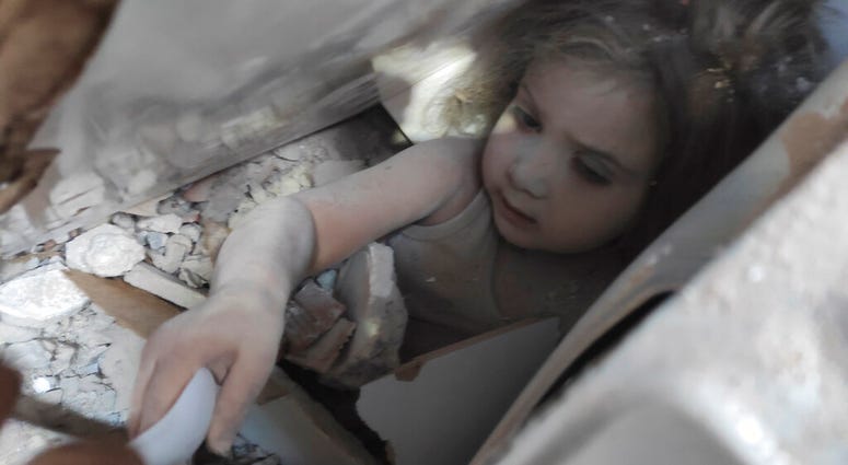 In this photo provided by the Turkish Gendarmerie, Ayda Gezgin is tended to by a member of rescue services in the rubble of her collapsed building, in Izmir, Turkey. (Turkish Gendarmerie via AP) In this photo provided by the Turkish Gendarmerie, Ayda Gezgin is tended to by a member of rescue services in the rubble of her collapsed building, in Izmir, Turkey. (Turkish Gendarmerie via AP)