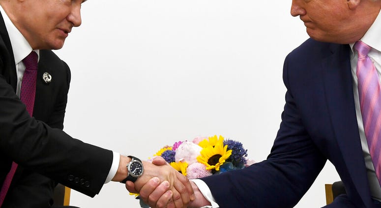 FILE - In this file photo taken on Friday, June 28, 2019, President Donald Trump, right, shakes hands with Russian President Vladimir Putin. (AP Photo/Susan Walsh, File) FILE - In this file photo taken on Friday, June 28, 2019, President Donald Trump, right, shakes hands with Russian President Vladimir Putin. (AP Photo/Susan Walsh, File)