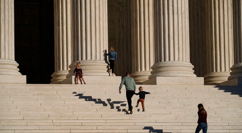 A family visits the Supreme Court in Washington, Wednesday, Nov. 4, 2020. (AP Photo/J. Scott Applewhite) A family visits the Supreme Court in Washington, Wednesday, Nov. 4, 2020. (AP Photo/J. Scott Applewhite)