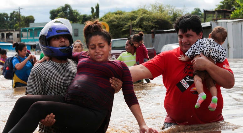 A pregnant woman is carried out of an area flooded by water brought by Hurricane Eta in Planeta, Honduras, Thursday, Nov. 5, 2020. (AP Photo/Delmer Martinez) A pregnant woman is carried out of an area flooded by water brought by Hurricane Eta in Planeta, Honduras, Thursday, Nov. 5, 2020. (AP Photo/Delmer Martinez)