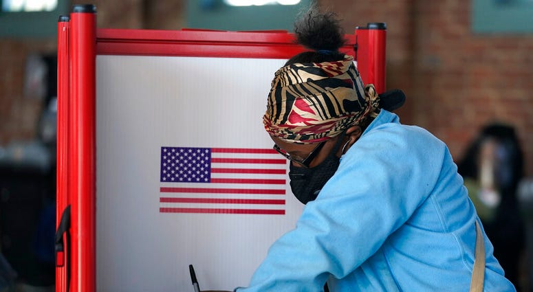 In this Tuesday, Nov. 3, 2020, file photo, Johnea Barlow casts her ballot at the Kentucky Center for African American Heritage, on Election Day in Louisville, Ky. (AP Photo/Darron Cummings, File) In this Tuesday, Nov. 3, 2020, file photo, Johnea Barlow casts her ballot at the Kentucky Center for African American Heritage, on Election Day in Louisville, Ky. (AP Photo/Darron Cummings, File)