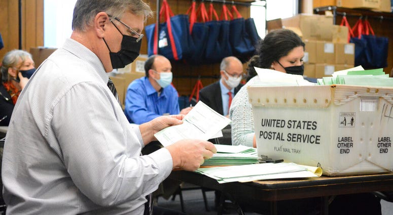 Election Bureau Director Albert L. Gricoski, left, opens provisional ballots alongside election bureau staff Christine Marmas, right, in Pottsville, Pa. on Tuesday, Nov. 10, 2020. (Lindsey Shuey/The Republican-Herald via AP) Election Bureau Director Albert L. Gricoski, left, opens provisional ballots alongside election bureau staff Christine Marmas, right, in Pottsville, Pa. on Tuesday, Nov. 10, 2020. (Lindsey Shuey/The Republican-Herald via AP)