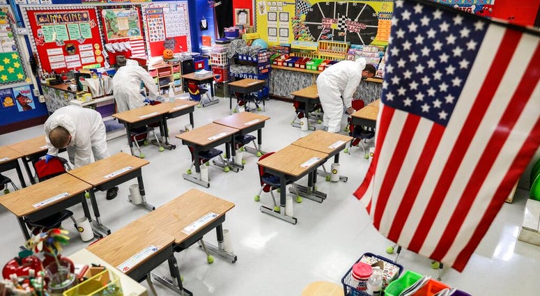 In this Nov. 5, 2020, file photo, custodial workers clean a classroom at Richard A. Simpson Elementary School in Arnold, Mo. (Colter Peterson/St. Louis Post-Dispatch via AP, File) In this Nov. 5, 2020, file photo, custodial workers clean a classroom at Richard A. Simpson Elementary School in Arnold, Mo. (Colter Peterson/St. Louis Post-Dispatch via AP, File)