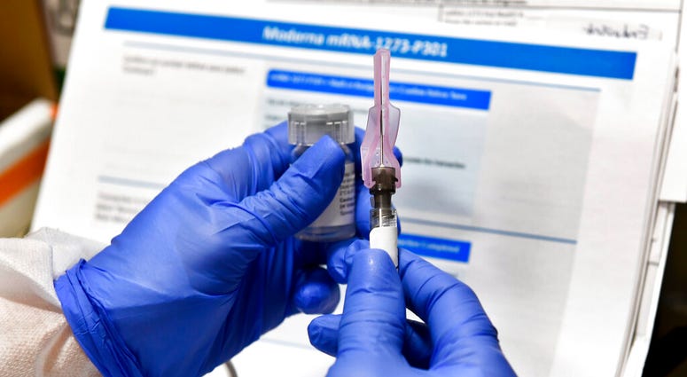 In this July 27, 2020, file photo, nurse Kathe Olmstead prepares a shot that is part of a possible COVID-19 vaccine, developed by the National Institutes of Health and Moderna Inc., in Binghamton, N.Y. (AP Photo/Hans Pennink, File) In this July 27, 2020, file photo, nurse Kathe Olmstead prepares a shot that is part of a possible COVID-19 vaccine, developed by the National Institutes of Health and Moderna Inc., in Binghamton, N.Y. (AP Photo/Hans Pennink, File)