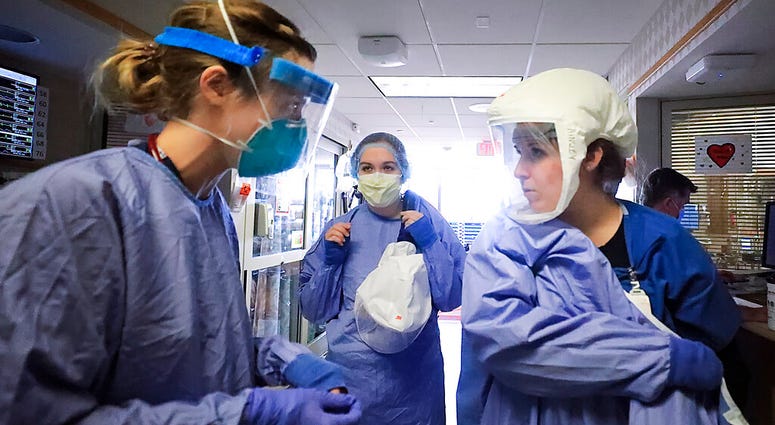 In this Nov. 5, 2020, file photo, medical staff attending to patients with COVID-19 wear protective equipment in a unit dedicated to treatment of the coronavirus at UW Health in Madison, Wis. (John Hart/Wisconsin State Journal via AP, File) In this Nov. 5, 2020, file photo, medical staff attending to patients with COVID-19 wear protective equipment in a unit dedicated to treatment of the coronavirus at UW Health in Madison, Wis. (John Hart/Wisconsin State Journal via AP, File)