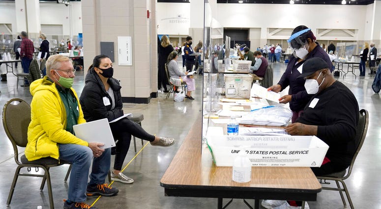 FILE - In this Nov. 20, 2020, file photo, election workers, right, verify ballots as recount observers, left, watch during a Milwaukee hand recount of presidential votes at the Wisconsin Center in Milwaukee. (AP Photo/Nam Y. Huh File) FILE - In this Nov. 20, 2020, file photo, election workers, right, verify ballots as recount observers, left, watch during a Milwaukee hand recount of presidential votes at the Wisconsin Center in Milwaukee. (AP Photo/Nam Y. Huh File)