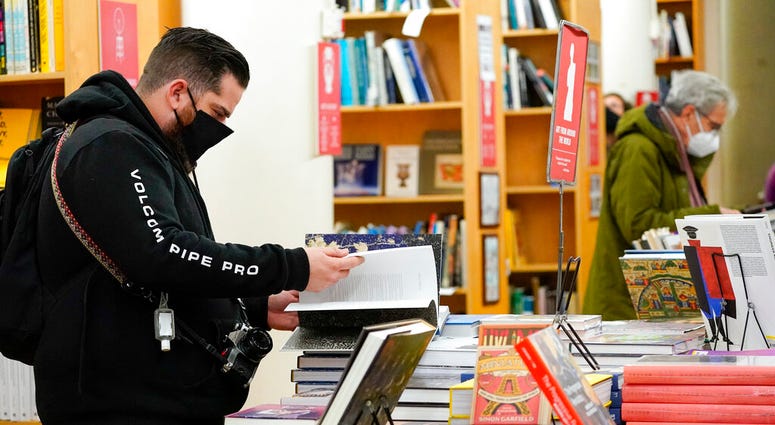 In this Saturday, Nov. 28, 2020, file photo, customers browse while shopping for books at the Strand Bookstore, an independent family owned bookstore founded in 1927 in New York. (AP Photo/Mary Altaffer) In this Saturday, Nov. 28, 2020, file photo, customers browse while shopping for books at the Strand Bookstore, an independent family owned bookstore founded in 1927 in New York. (AP Photo/Mary Altaffer)