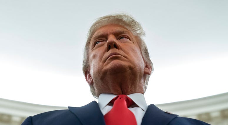 President Donald Trump listens during a ceremony to present the Presidential Medal of Freedom to former football coach Lou Holtz, in the Oval Office of the White House, Thursday, Dec. 3, 2020, in Washington. (AP Photo/Evan Vucci) President Donald Trump listens during a ceremony to present the Presidential Medal of Freedom to former football coach Lou Holtz, in the Oval Office of the White House, Thursday, Dec. 3, 2020, in Washington. (AP Photo/Evan Vucci)