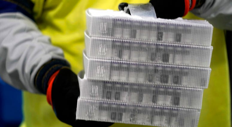 Boxes containing the Pfizer-BioNTech COVID-19 vaccine are prepared to be shipped at the Pfizer Global Supply Kalamazoo manufacturing plant in Portage, Mich.