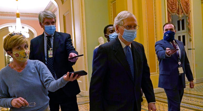 Senate Majority Leader Mitch McConnell of Ky., walks past reporters on Capitol Hill in Washington, Tuesday, Dec. 15, 2020.