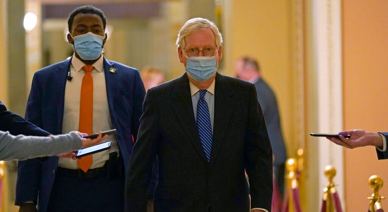 Senate Majority Leader Mitch McConnell of Ky., walks past reporters on Capitol Hill in Washington, Tuesday, Dec. 15, 2020.