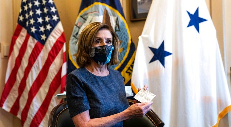 Speaker of the House Nancy Pelosi, D-Calif., sits after receiving a Pfizer-BioNTech COVID-19 vaccine shot in Washington, Friday, Dec. 18, 2020.