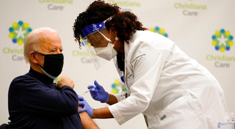 President-elect Joe Biden receives his first dose of the coronavirus vaccine at ChristianaCare Christiana Hospital in Newark, Del., Monday, Dec. 21, 2020, from nurse practitioner Tabe Mase. (AP Photo/Carolyn Kaster) President-elect Joe Biden receives his first dose of the coronavirus vaccine at ChristianaCare Christiana Hospital in Newark, Del., Monday, Dec. 21, 2020, from nurse practitioner Tabe Mase. (AP Photo/Carolyn Kaster)