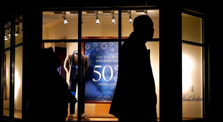 In this Saturday, Dec. 19, 2020 file photo, people walk past the window display of a store in Skokie, Ill. (AP Photo/Nam Y. Huh) In this Saturday, Dec. 19, 2020 file photo, people walk past the window display of a store in Skokie, Ill. (AP Photo/Nam Y. Huh)