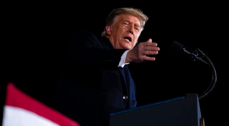 President Donald Trump speaks during a campaign rally for Sen. Kelly Loeffler, R-Ga., and David Perdue, at Dalton Regional Airport, Monday, Jan. 4, 2021, in Dalton, Ga. (AP Photo/Evan Vucci) President Donald Trump speaks during a campaign rally for Sen. Kelly Loeffler, R-Ga., and David Perdue, at Dalton Regional Airport, Monday, Jan. 4, 2021, in Dalton, Ga. (AP Photo/Evan Vucci)