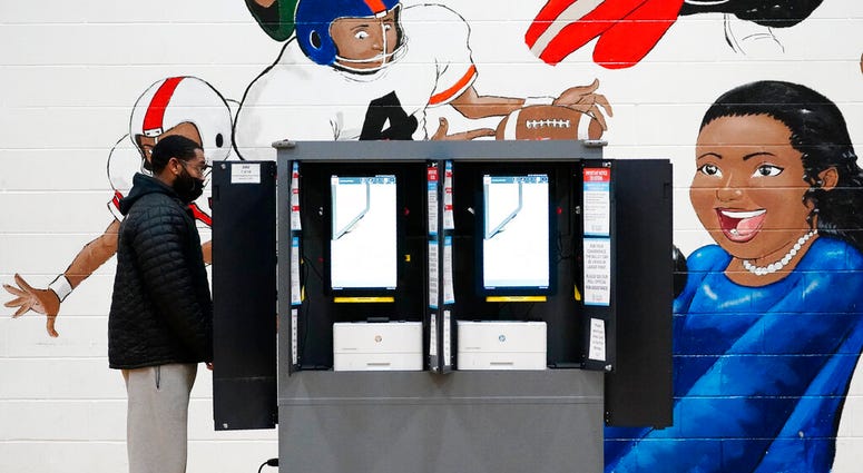 A person casts their vote during Georgia's Senate runoff elections on Tuesday, Jan. 5, 2021, in Atlanta. (AP Photo/Brynn Anderson) A person casts their vote during Georgia's Senate runoff elections on Tuesday, Jan. 5, 2021, in Atlanta. (AP Photo/Brynn Anderson)