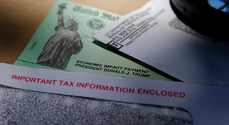 FILE - In this April 23, 2020, file photo, President Donald Trump's name is seen on a stimulus check issued by the IRS to help combat the adverse economic effects of the COVID-19 outbreak, in San Antonio.