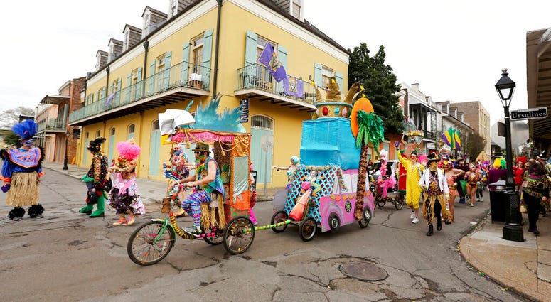 FILE - In this Tuesday, Feb. 25, 2020, file photo, Mondo Kayo parades down Chartres Street during Mardi Gras, in New Orleans. (AP Photo/Rusty Costanza, File) FILE - In this Tuesday, Feb. 25, 2020, file photo, Mondo Kayo parades down Chartres Street during Mardi Gras, in New Orleans. (AP Photo/Rusty Costanza, File)