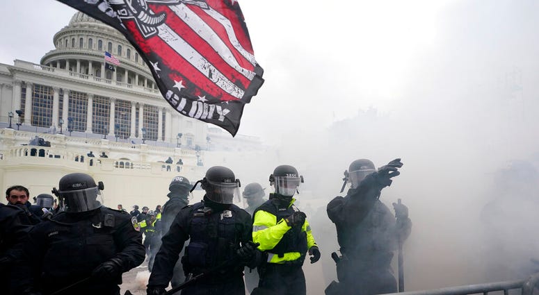 Police hold off Trump supporters who tried to break through a police barrier, Wednesday, Jan. 6, 2021, at the Capitol in Washington.