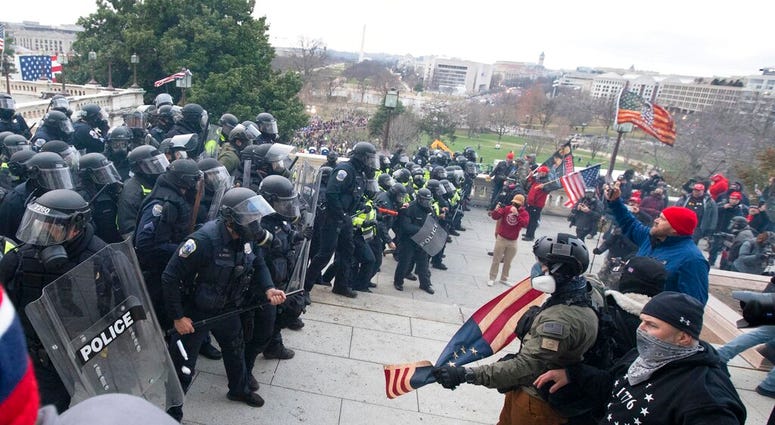 U.S. Capitol Police push back demonstrators who were trying to enter the U.S. Capitol on Wednesday, Jan. 6, 2021, in Washington.