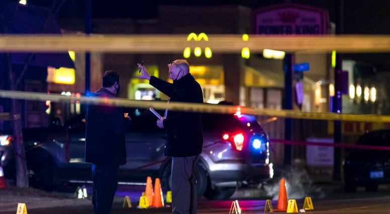Chicago and Evanston police investigate a crime scene after a gunman went on a shooting spree before being killed by police during a shootout in Evanston, Ill., Saturday night, Jan. 9, 2021.