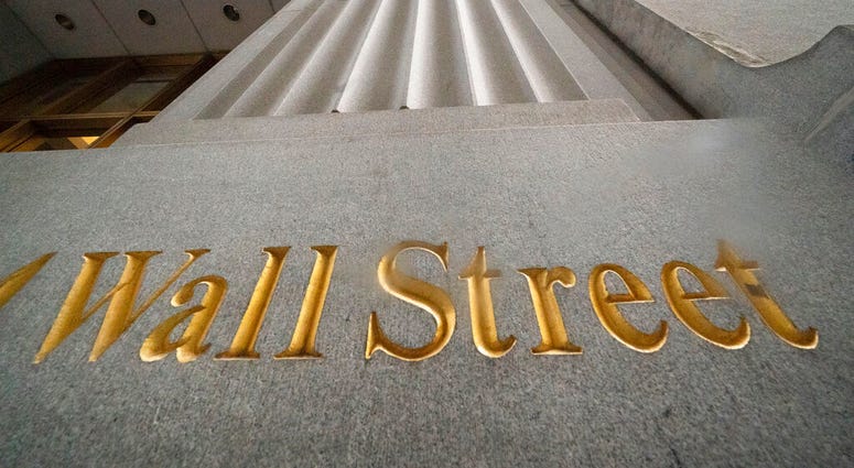 In this Nov. 5, 2020 file photo, a sign for Wall Street is carved in the side of a building. (AP Photo/Mark Lennihan, File) In this Nov. 5, 2020 file photo, a sign for Wall Street is carved in the side of a building. (AP Photo/Mark Lennihan, File)