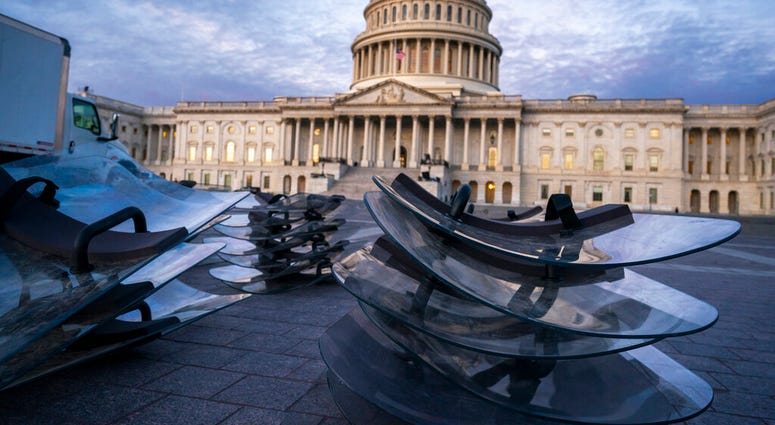 Riot shields are stacked at the ready as National Guard troops reinforce the security zone on Capitol Hill in Washington, Tuesday, Jan. 19, 2021, before President-elect Joe Biden is sworn in as president on Wednesday.(AP Photo/J. Scott Applewhite) Riot shields are stacked at the ready as National Guard troops reinforce the security zone on Capitol Hill in Washington, Tuesday, Jan. 19, 2021, before President-elect Joe Biden is sworn in as president on Wednesday.(AP Photo/J. Scott Applewhite)