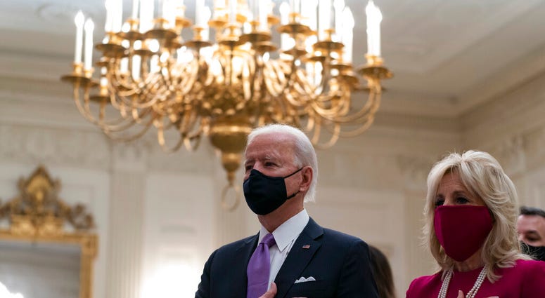President Joe Biden, accompanied by first lady Jill Biden, places his hand over his heart during a performance of the national anthem, during a virtual Presidential Inaugural Prayer Service. (AP Photo/Alex Brandon) President Joe Biden, accompanied by first lady Jill Biden, places his hand over his heart during a performance of the national anthem, during a virtual Presidential Inaugural Prayer Service. (AP Photo/Alex Brandon)