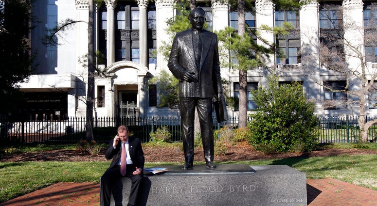 FILE - House Majority Leader H. Morgan Griffith, R-Salem, talks on a phone as he sits at the feet of the statue of former Gov. and U.S.