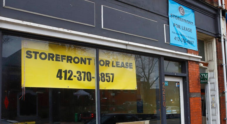 FILE - In this Jan. 7, 2021, file photo, an empty storefront is seen among other businesses along East Carson Street in the Southside neighborhood of Pittsburgh.