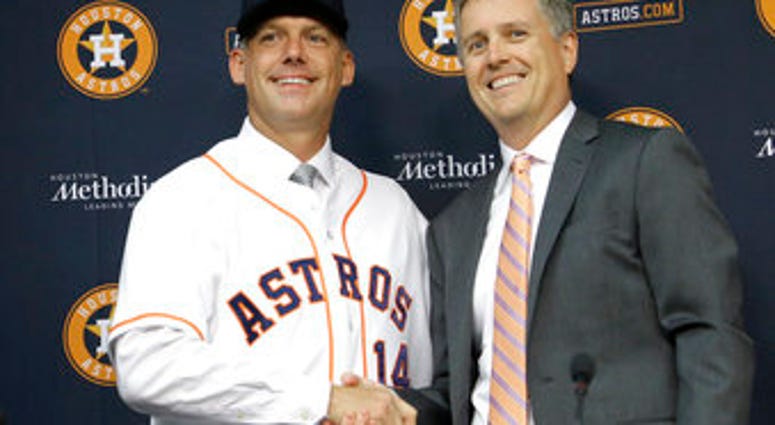 FILE - In this Sept. 29, 2014, file photo, Houston Astros general manager Jeff Luhnow, right, and A.J. Hinch pose after Hinch is introduced as the new manager of the baseball club in Houston. (AP Photo/Pat Sullivan, File) FILE - In this Sept. 29, 2014, file photo, Houston Astros general manager Jeff Luhnow, right, and A.J. Hinch pose after Hinch is introduced as the new manager of the baseball club in Houston. (AP Photo/Pat Sullivan, File)