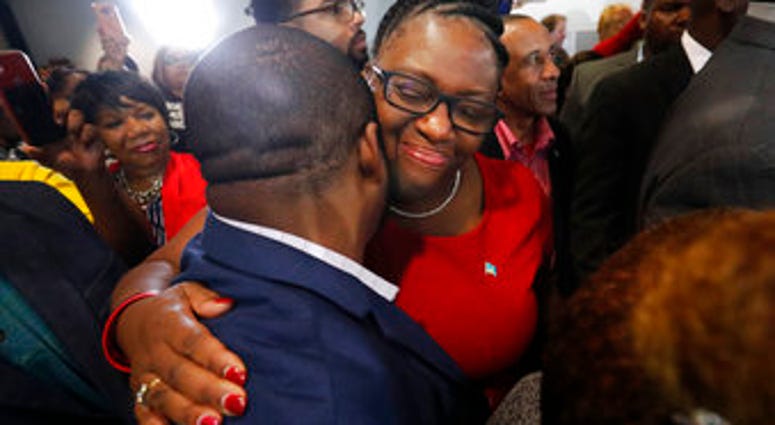 Allison Jean, center, the mother of Botham Jean, hugs a supporter after fired Dallas police officer Amber Guyger was found guilty of murder, Tuesday, Oct. 1, 2019, in Dallas. (AP Photo/LM Otero)