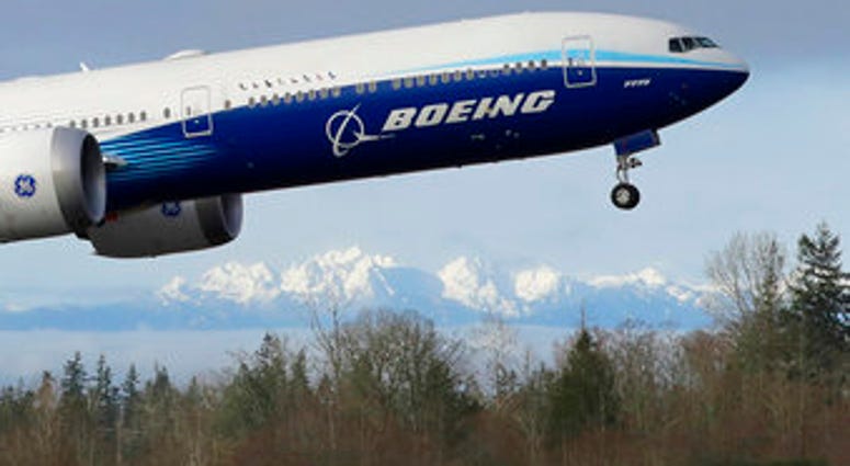 FILE - In this Jan. 25, 2020, file photo a Boeing 777X airplane takes off on its first flight with the Olympic Mountains in the background at Paine Field in Everett, Wash. (AP Photo/Ted S. Warren, File) FILE - In this Jan. 25, 2020, file photo a Boeing 777X airplane takes off on its first flight with the Olympic Mountains in the background at Paine Field in Everett, Wash. (AP Photo/Ted S. Warren, File)