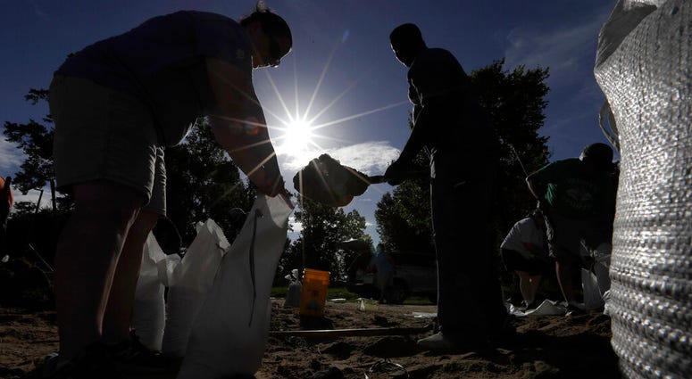 Residents fill sandbags Friday, July 12, 2019, in Baton Rouge, La., ahead of Tropical Storm Barry. (AP Photo/David J. Phillip)