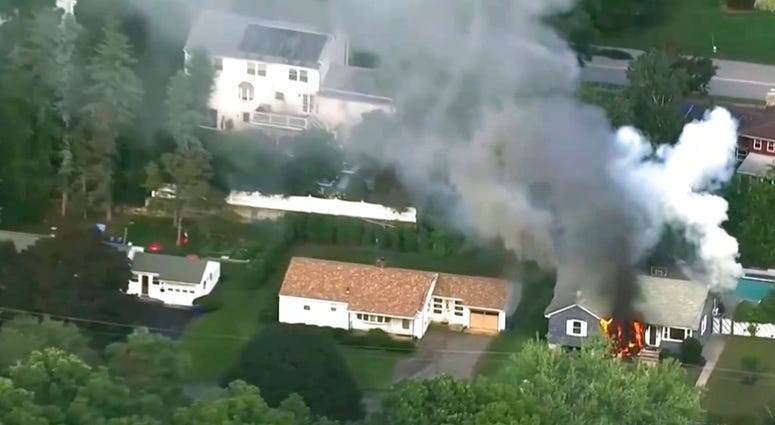 In this image take from video provided by WCVB in Boston, flames rise from a house in Lawrence, Mass, a suburb of Boston, Thursday, Sept. 13, 2018. Emergency crews are responding to what they believe is a series of gas explosions that have damaged homes a