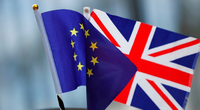 A protestor wears a hat with an EU and a Union flag as he participates in an anti-Brexit demonstration outside of an EU summit in Brussels, Thursday, Oct. 17, 2019. (AP Photo/Frank Augstein)
