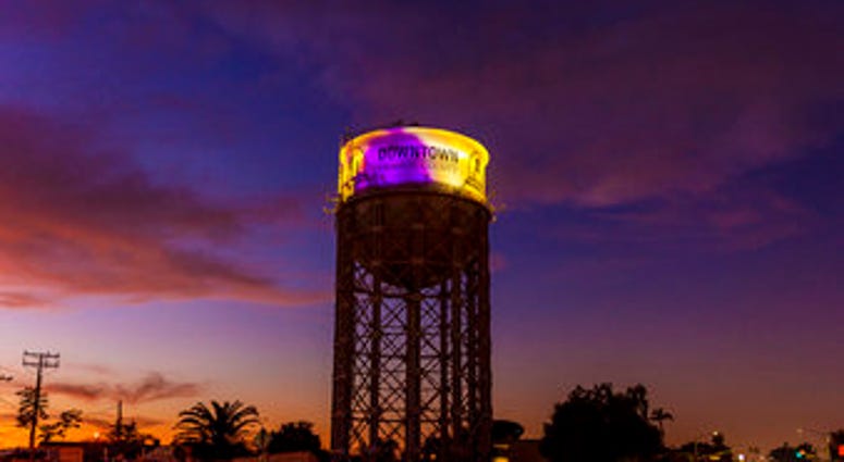 The historic 1928 Santa Ana water tower in Santa Ana, Calif., Monday, Jan. 27, 2020, is illuminated in purple and gold light in remembrance of Los Angeles Lakers legend Kobe Bryant. (Leonard Ortiz/The Orange County Register via AP) The historic 1928 Santa Ana water tower in Santa Ana, Calif., Monday, Jan. 27, 2020, is illuminated in purple and gold light in remembrance of Los Angeles Lakers legend Kobe Bryant. (Leonard Ortiz/The Orange County Register via AP)