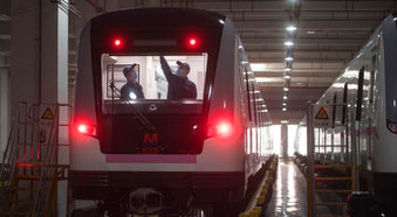 In this March 23, 2020 photo released by Xinhua News Agency, workers prepares a subway train for restoration of public transport in Wuhan, in central China's Hubei province. (Xiao Yijiu/Xinhua via AP) In this March 23, 2020 photo released by Xinhua News Agency, workers prepares a subway train for restoration of public transport in Wuhan, in central China's Hubei province. (Xiao Yijiu/Xinhua via AP)