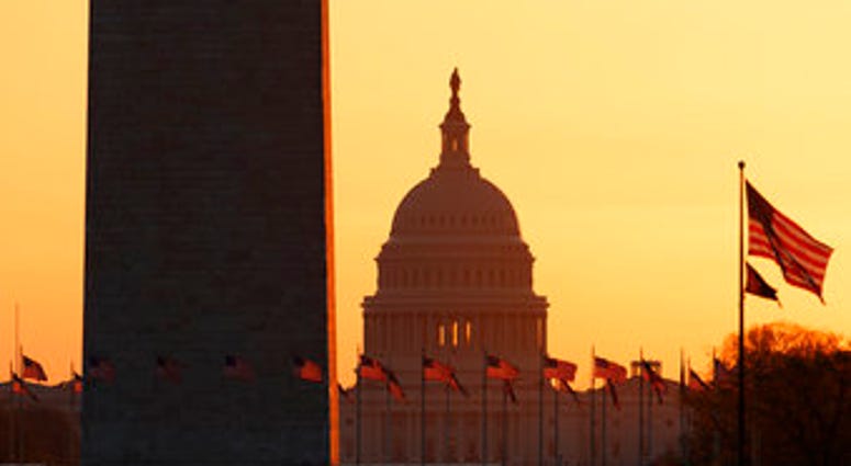 The Washington Monument and the U.S. Capitol are seen in Washington, at sunrise Wednesday, March 18, 2020. The White House has sent Congress an emergency $46 billion spending request for coronavirus-related funding this year. (AP Photo/Carolyn Kaster) The Washington Monument and the U.S. Capitol are seen in Washington, at sunrise Wednesday, March 18, 2020. The White House has sent Congress an emergency $46 billion spending request for coronavirus-related funding this year. (AP Photo/Carolyn Kaster)
