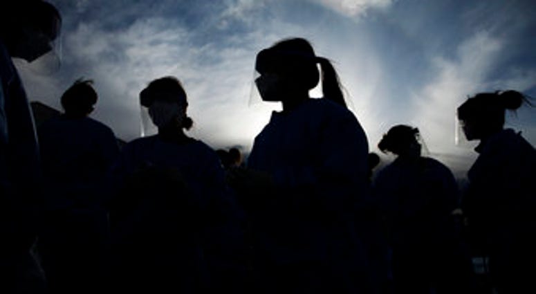 In this Saturday, March 28, 2020 file photo, medical and physician assistant students wear personal protective equipment as they prepare to screen for possible coronavirus cases at a makeshift camp for the homeless in Las Vegas.(AP Photo/John Locher) In this Saturday, March 28, 2020 file photo, medical and physician assistant students wear personal protective equipment as they prepare to screen for possible coronavirus cases at a makeshift camp for the homeless in Las Vegas.(AP Photo/John Locher)