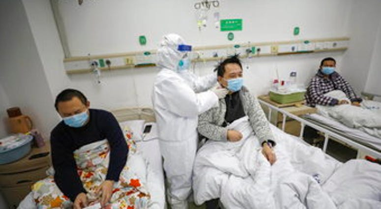 A doctor checks the conditions of a patient in Jinyintan Hospital, designated for critical COVID-19 patients, in Wuhan in central China's Hubei province Thursday, Feb. 13, 2020. (Chinatopix Via AP) A doctor checks the conditions of a patient in Jinyintan Hospital, designated for critical COVID-19 patients, in Wuhan in central China's Hubei province Thursday, Feb. 13, 2020. (Chinatopix Via AP)