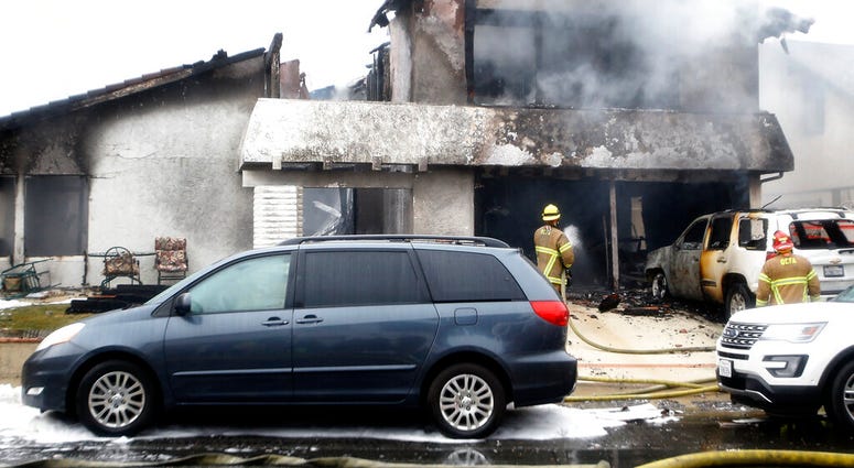 Firefighters respond to the scene of a plane crash at a home in Yorba Linda, Calif., Sunday, Feb. 3, 2019. A twin-engine Cessna 414A crashed in Yorba Linda shortly after taking off from the nearby Fullerton Municipal Airport. The Orange County Fire Author