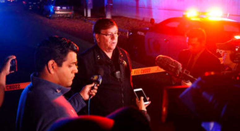 CORRECTS FROM FRESNO POLICE LT. BILL DOOLEY TO FRESNO POLICE DEPUTY CHIEF MICHAEL REED - Police Deputy Chief Michael Reed speaks to reporters at the scene of a shooting at a backyard party Sunday. (Larry Valenzuela/The Fresno Bee via AP)