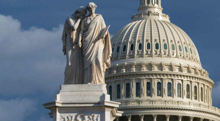 The Capitol is seen as the House is set to begin public impeachment inquiry hearings as lawmakers debate whether to remove President Donald Trump from office, in Washington, Nov. 12, 2019. At left is the Peace Monument. (AP Photo/J. Scott Applewhite)
