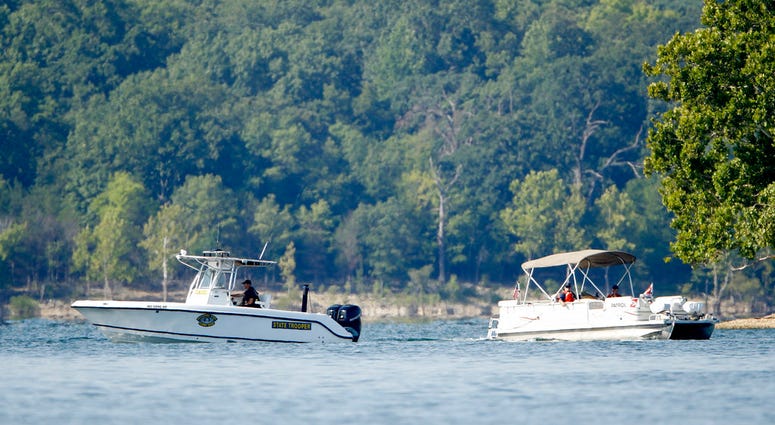 Emergency workers patrol an area Friday, July 20, 2018, near where a duck boat capsized the night before resulting in at least 13 deaths on Table Rock Lake in Branson, Mo. Workers were still searching for four people on the boat that were unaccounted for.