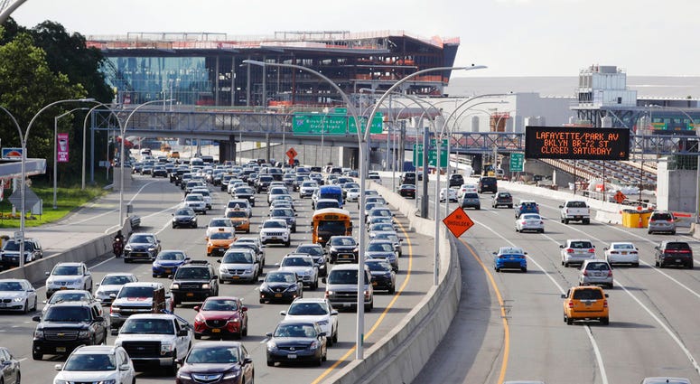 In this Aug. 1, 2018, photo, cars on Grand Central Parkway pass LaGuardia Airport in New York. The Trump administration has proposed rolling back tougher Obama-era gas mileage requirements that are set to take effect after 2020. (AP Photo/Frank Frankl)