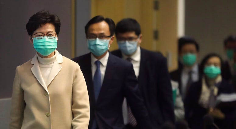 Hong Kong Chief Executive Carrie Lam, front, and other government officials wear protective face masks before a press conference in Hong Kong, Friday, Jan. 31, 2020. (AP Photo/Achmad Ibrahim) Hong Kong Chief Executive Carrie Lam, front, and other government officials wear protective face masks before a press conference in Hong Kong, Friday, Jan. 31, 2020. (AP Photo/Achmad Ibrahim)