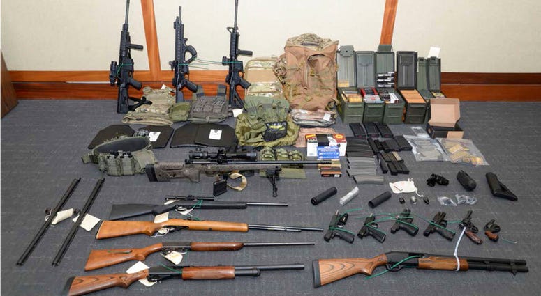 This image provided by the U.S. District Court in Maryland shows a photo of firearms and ammunition that was in the motion for detention pending trial in the case against Christopher Paul Hasson. (U.S. District Court via AP)
