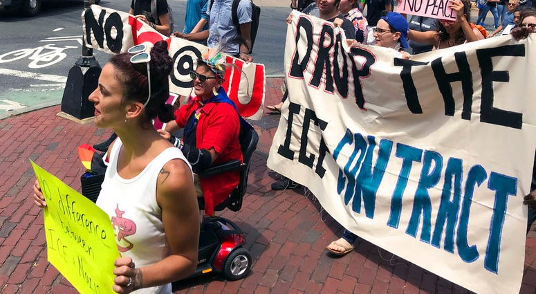 FILE - In this July 11, 2018 file photo, students and community activists march at Northeastern University in Boston demanding the school cancel a multimillion-dollar research contract with U.S. Immigration and Customs Enforcement. Northeastern was hired